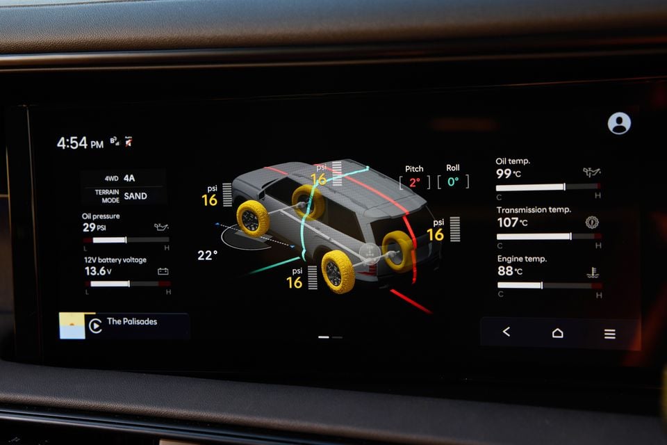 The infotainment screen of a 2026 Hyundai Palisade XRT Pro displaying an off-road telemetry screen with tyre pressure readings, pitch and roll angles, terrain mode set to sand, oil pressure, battery voltage, and engine temperatures.