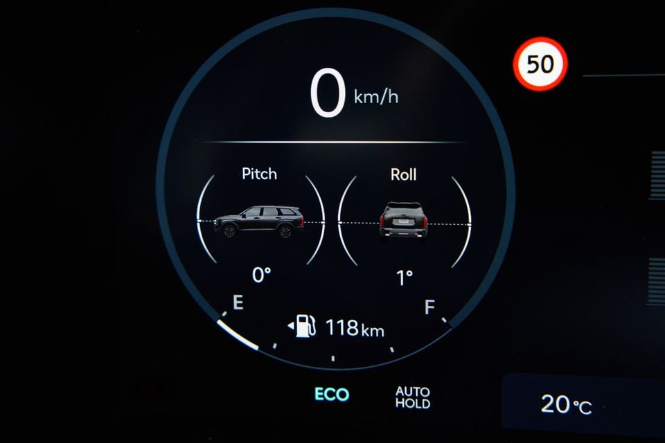 Digital instrument cluster display in a 2026 Hyundai Palisade XRT Pro showing pitch and roll indicators, speedometer reading 0 km/h, fuel range of 118 km, ECO and Auto Hold modes active, and a 50 km/h speed sign detected.