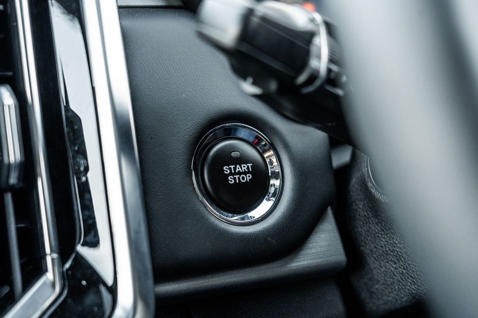 Close-up of the push-button engine start/stop button on the dashboard of a 2026 JAC Hunter PHEV