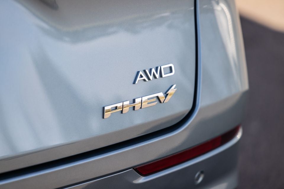 Close-up of the AWD and PHEV badges on the rear of a grey Jaecoo J8