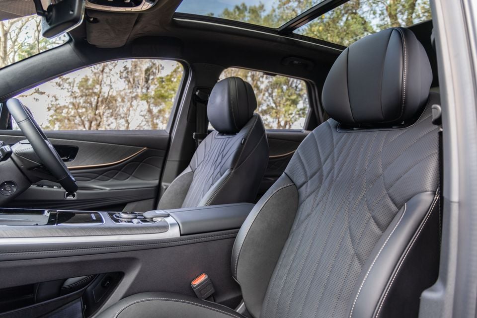 Interior view of a 2026 Jaecoo J8 showing quilted leather front seats, centre console, and panoramic sunroof