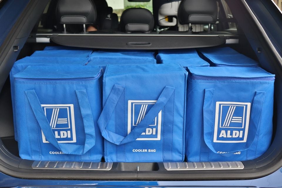 Six blue Aldi cooler bags filling the boot of a blue SUV, showing cargo space capacity