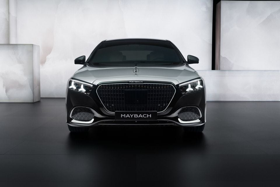Front view of a Mercedes-Maybach S-Class sedan in silver and black, photographed in a studio setting