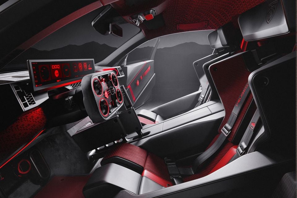 Interior of the 2026 Peugeot E-T16 concept showing red-and-grey bucket seats with harnesses, a rectangular steering wheel and a wide digital display
