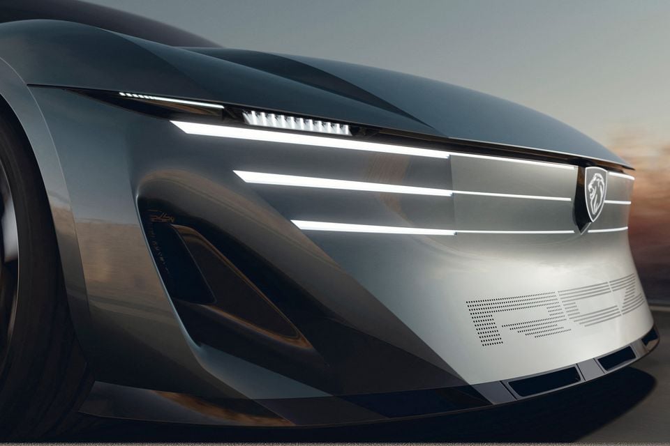 Front end of the silver Peugeot Vision RCZ concept, showing its illuminated three-line light signature, lion badge and dotted RCZ lettering