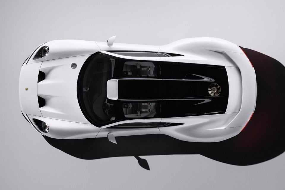 A white 2026 Porsche Mission E concept hypercar seen from directly above in a studio, showing its glass canopy and twin seats