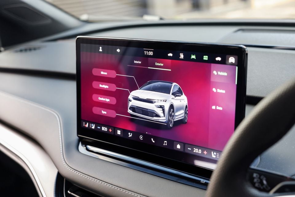 The touchscreen infotainment display in a 2026 Skoda Enyaq showing the exterior vehicle settings menu with options for mirrors, headlights, comfort light and tyres
