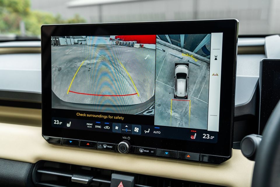 The infotainment screen of a 2026 Toyota RAV4 Cruiser shows a surround-view camera display with front and overhead parking views.