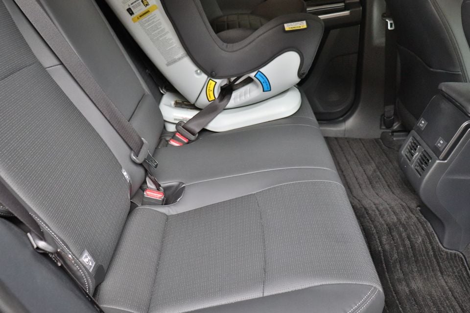 Rear passenger seat of a 2026 Toyota bZ4X with a child car seat installed in the rear-facing position, secured with a seatbelt