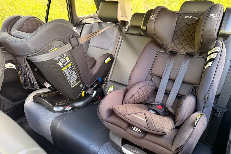 Two child car seats, one rear-facing and one forward-facing InfaSecure Momentum, fitted to the back seat of a 2026 Toyota RAV4