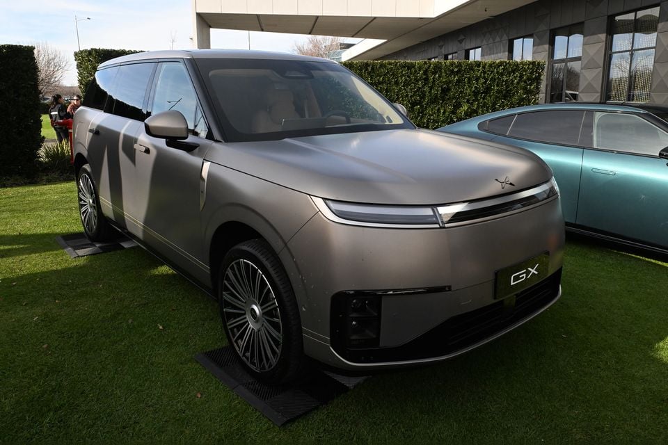 A grey 2026 Xpeng GX large SUV seen from the front-side angle, displayed on grass at an outdoor event in Melbourne.