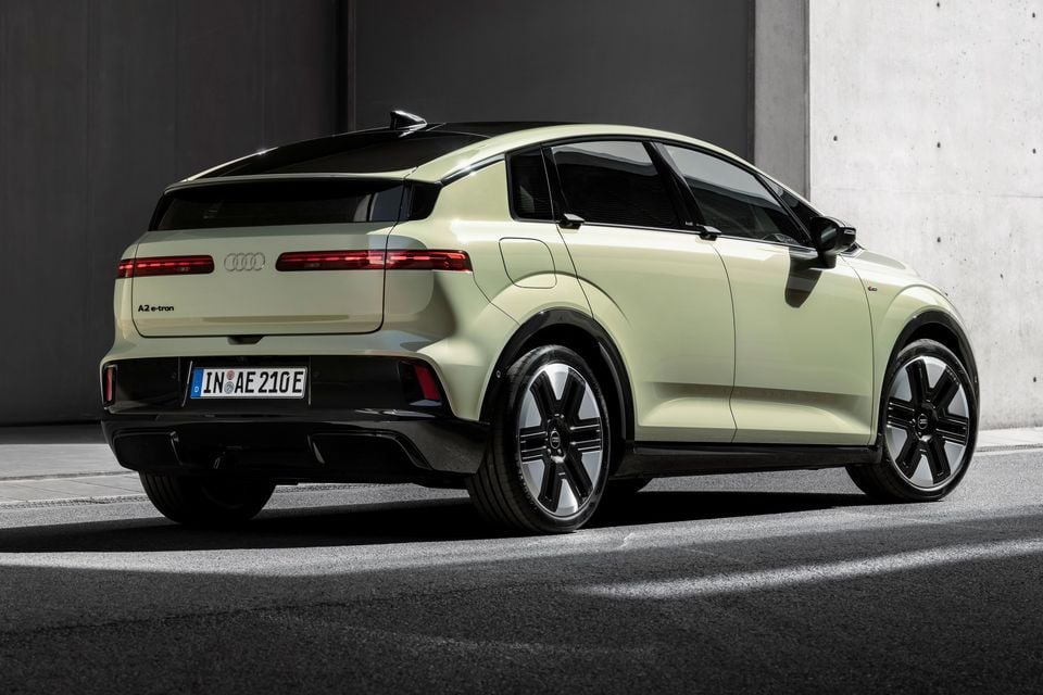 Audi A2 e-tron electric SUV seen from the rear three-quarter angle, finished in light green with a black roof
