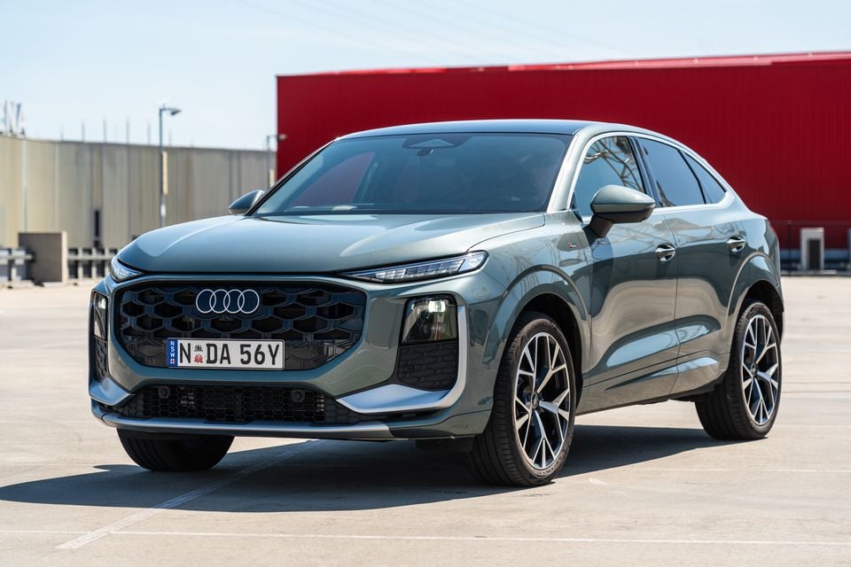 A green 2027 Audi Q3 Sportback SUV parked in a lot, viewed from the front corner