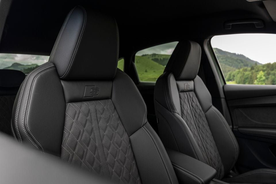 Black leather front seats with diamond-stitched upholstery and Audi S badging inside a 2027 Audi Q4 e-tron
