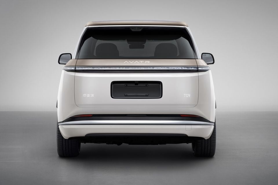 Rear view of the Avatr T09 SUV shown against a studio background, featuring a full-width light bar and two-tone white and gold finish