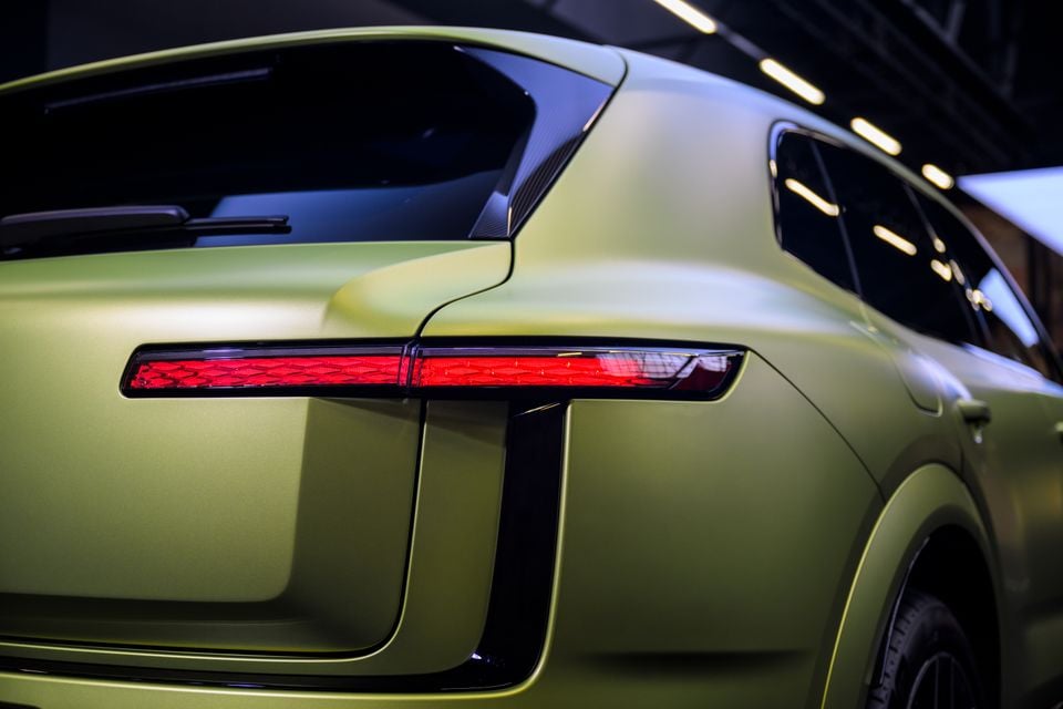 Close-up of the rear tail light and quarter panel of a green Bentley Torcal concept car indoors