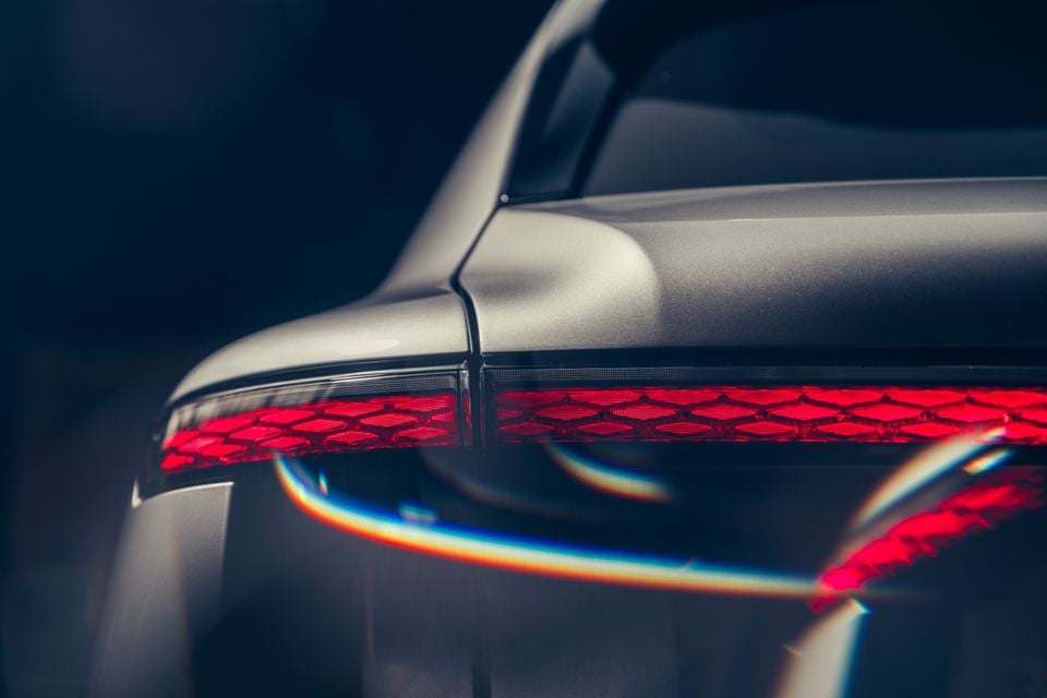 Close-up of the rear tail light on a grey Bentley Torcal, showing a red honeycomb-patterned lens design