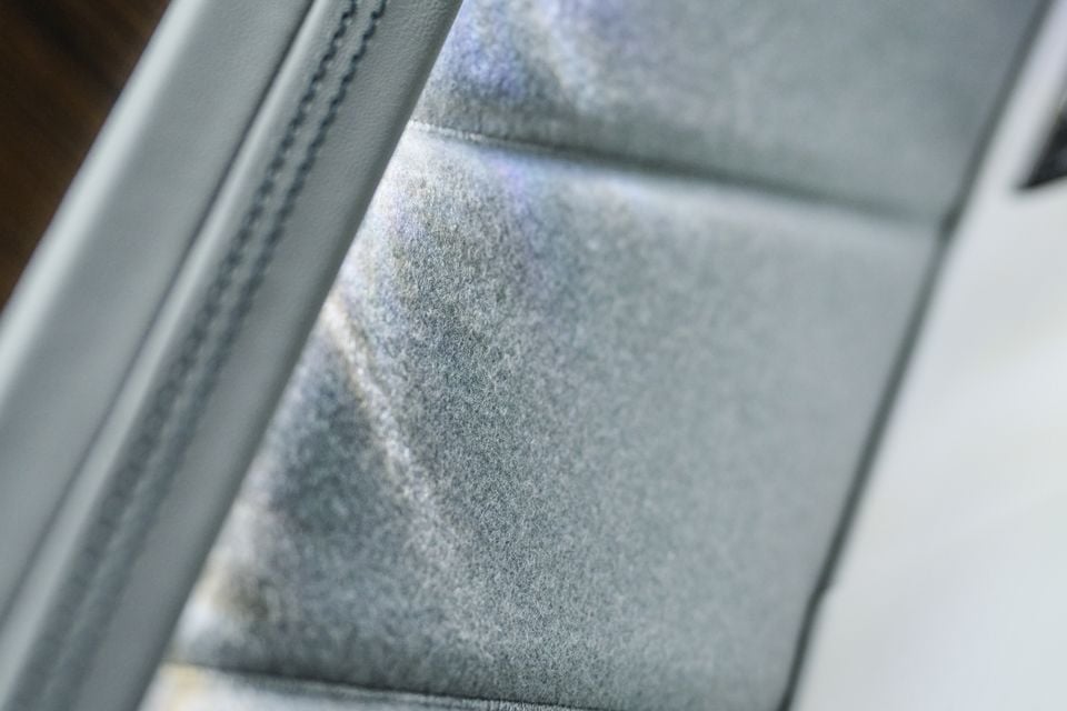 Close-up of a grey suede or Alcantara car seat with stitched detailing, likely from a Bentley Torcal concept