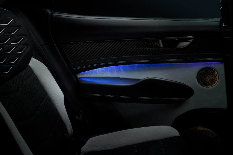 Interior door panel of the Bentley Torcal concept car featuring blue ambient lighting and a Naim audio speaker