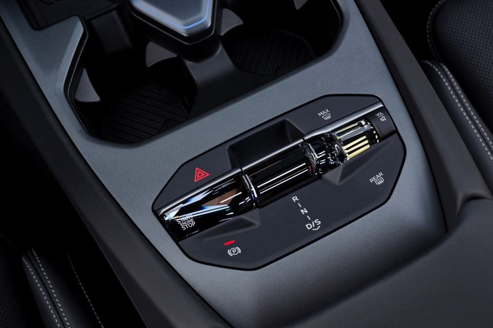 Centre console of the 2027 BMW M350 3 Series with crystal-effect start button, gear selector, hazard switch and cupholders