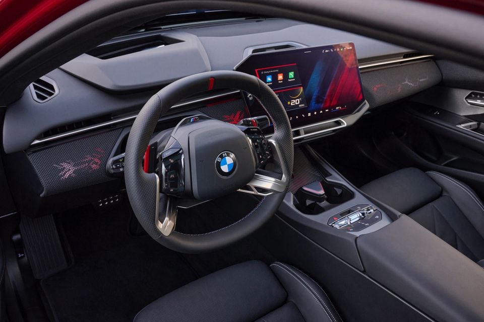 Dashboard of the 2027 BMW M350 3 Series with an M steering wheel, curved infotainment screen and black leather front seats