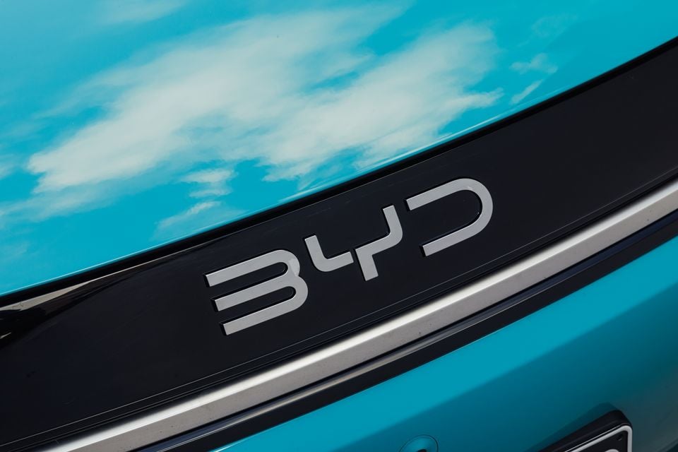 Close-up of the BYD badge on the rear of a teal-coloured car with a black trim strip