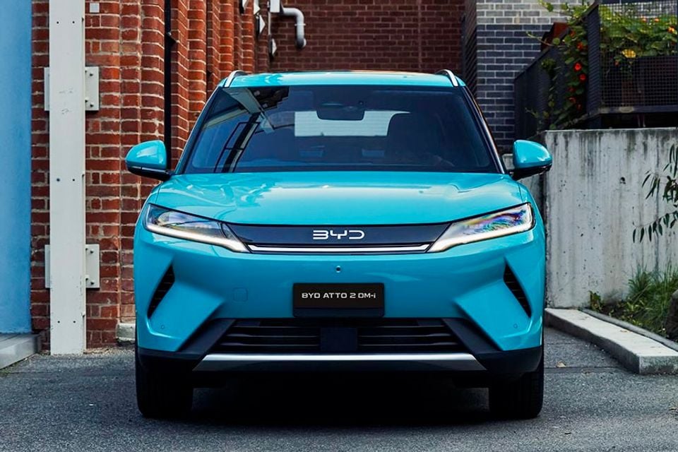 A blue BYD Atto 2 DM-i SUV parked in a laneway, seen from the front