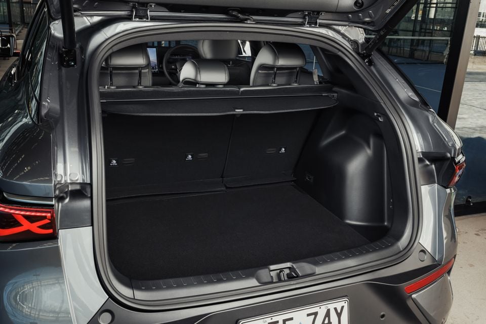 The open boot of a 2027 BYD Atto 3 Evo, showing the empty cargo area with the rear seats folded down.
