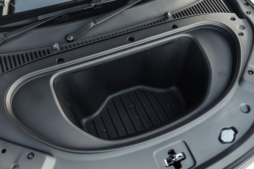 A 2027 BYD Atto 3 Evo shows its empty front trunk storage compartment under the bonnet.