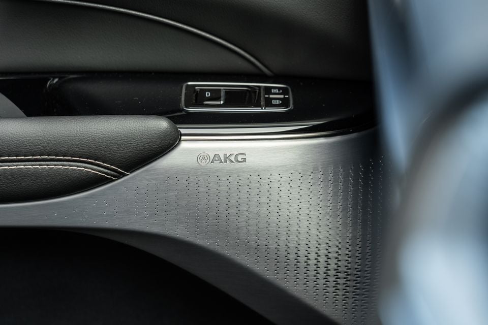 AKG speaker grille on the door panel of a 2027 Cadillac Lyriq V, with window controls visible above