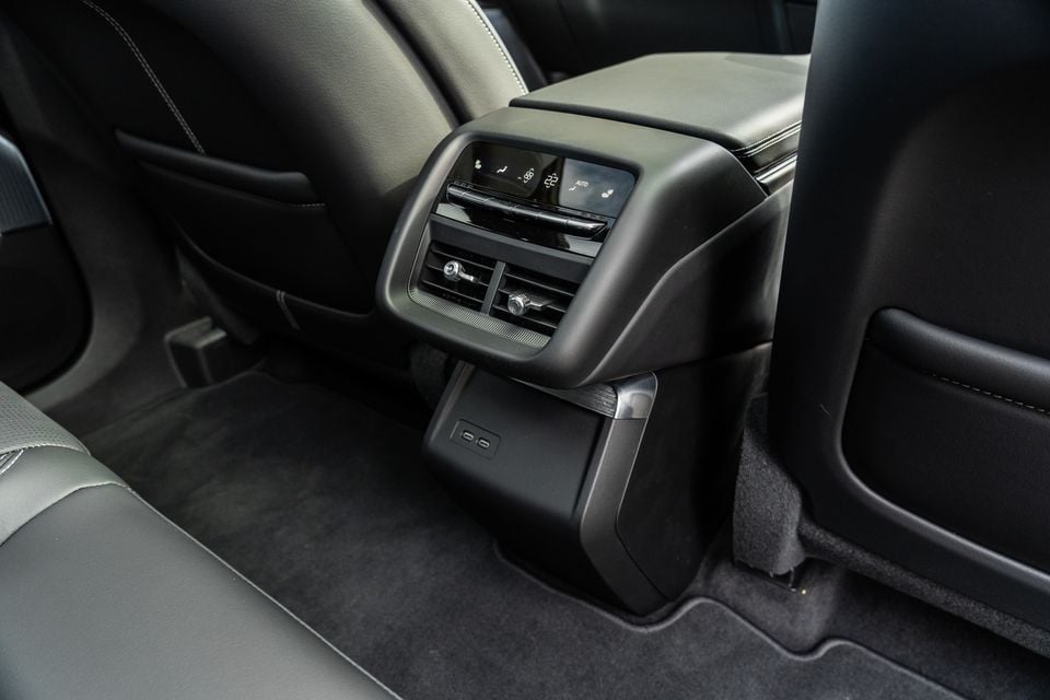 Rear centre console of the 2027 Cadillac LYRIQ showing rear climate controls, air vents, and USB-C charging ports between the back seats