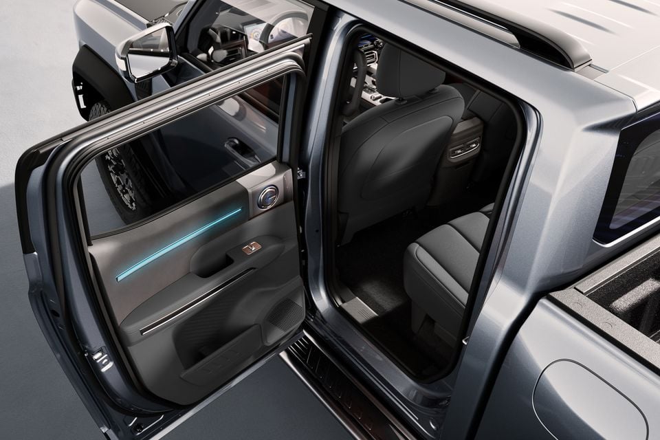 Interior view of a 2027 Chery Stockman with the rear door open, showing the door panel with ambient lighting and rear seating area