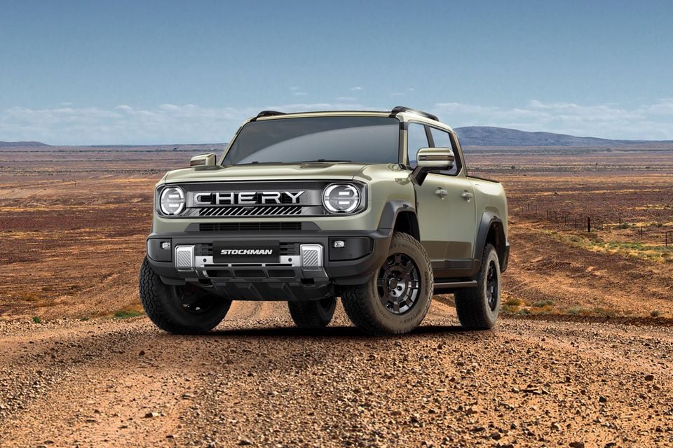 A Chery Stockman dual-cab ute in olive green, seen from the front at a slight angle on a dirt outback road with an arid landscape in the background.