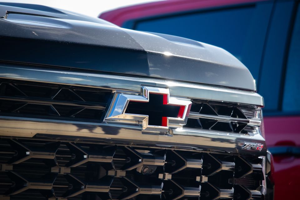 Close-up of the Chevrolet bowtie badge and ZR2 badge on the front grille of a Chevrolet Silverado ZR2