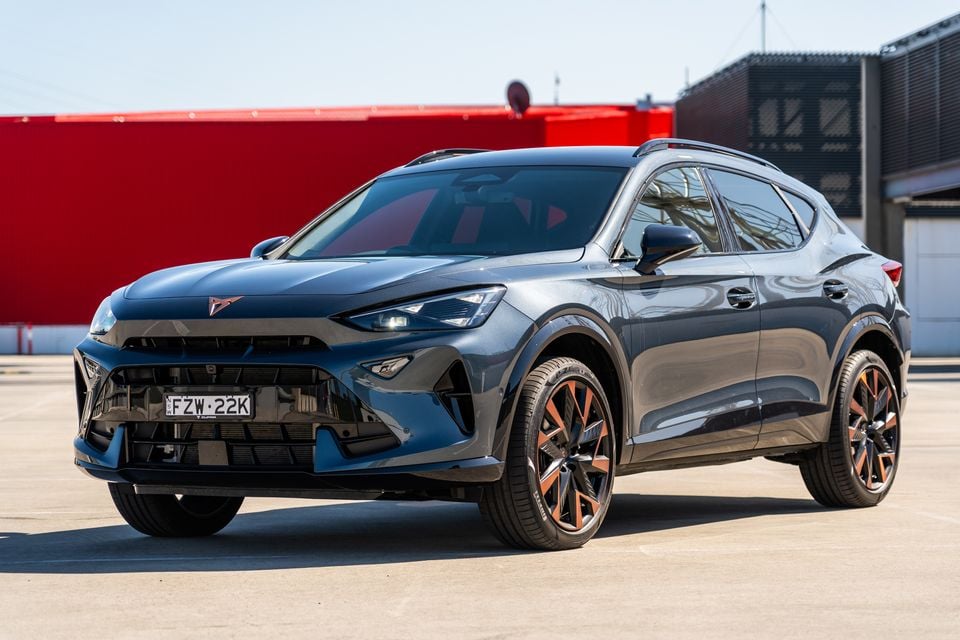 A grey 2027 Cupra Formentor V SUV parked in a lot, seen from the front quarter view