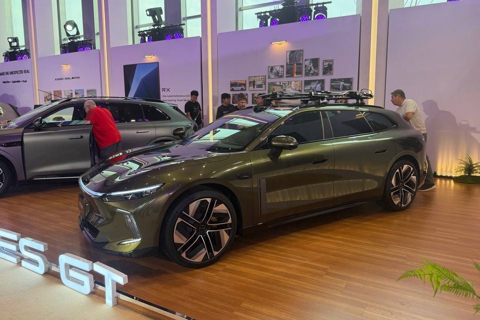 Green Exlantix ES GT shooting brake with roof-mounted sports equipment at the Shanghai display, with an Exlantix ET behind it.