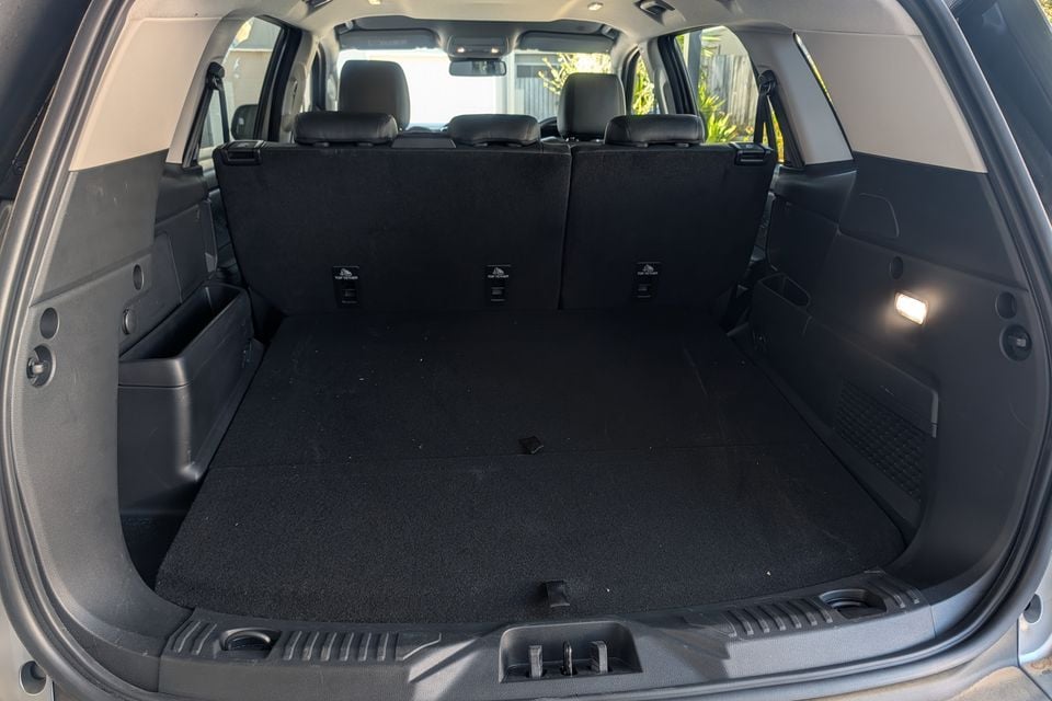 The boot of a Ford Everest SUV showing a large empty cargo area with folded rear seats and top-tether anchor points