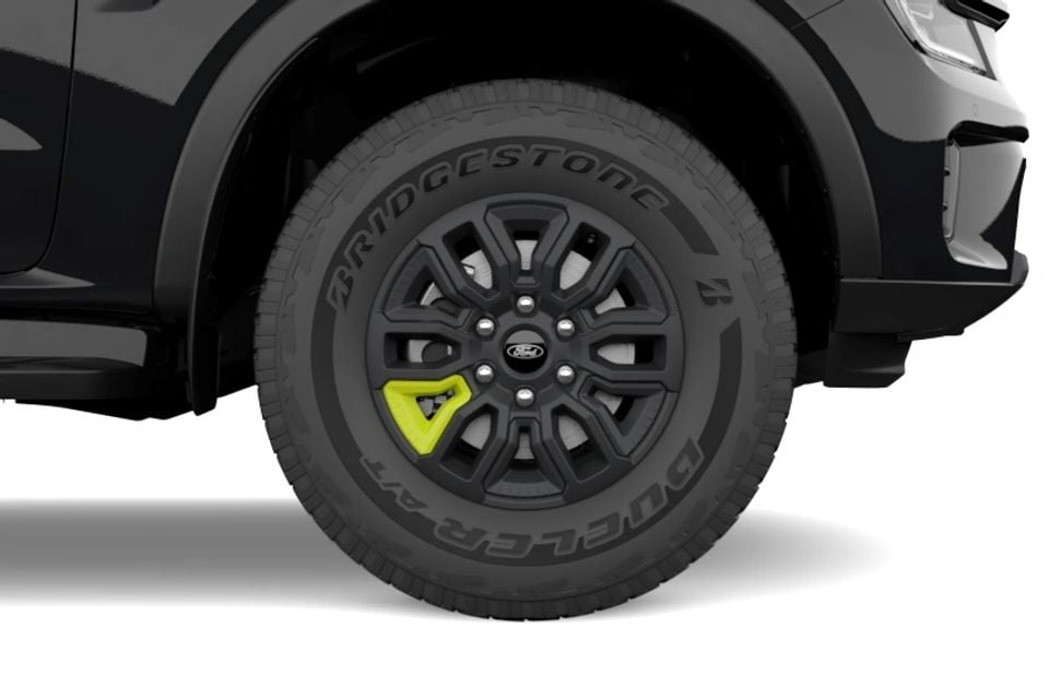 Close-up of the black alloy wheel with yellow accent and Bridgestone Dueler tyre on a 2027 Ford Everest Wolftrak