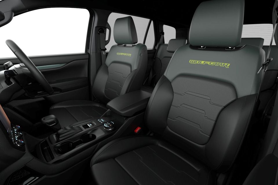 The front seats and centre console of a 2027 Ford Everest Wolftrak, featuring grey and black leather upholstery with Wolftrak branding.