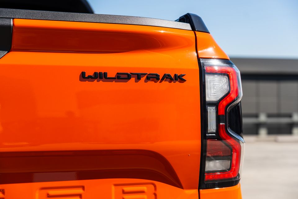 Close-up of the rear taillight and Wildtrak badge on an orange Ford Ranger Wildtrak ute