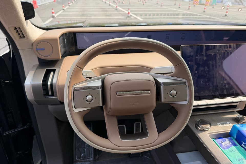 Freelander 8 steering wheel and dashboard in the tan-trimmed cabin