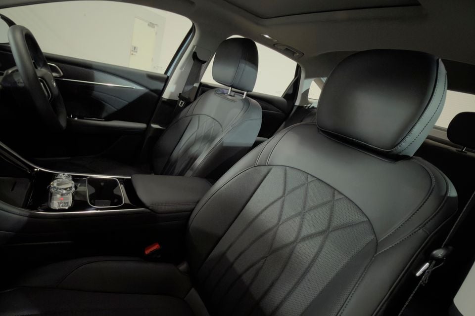 Black leather front seats of a Geely Emgrand L, showing diamond-stitched upholstery and centre console