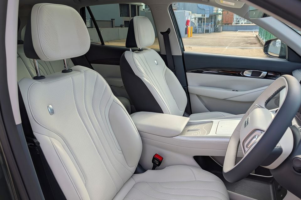 Light grey leather front seats and centre console inside a Geely GX5 Inspire, viewed from the driver's side door opening