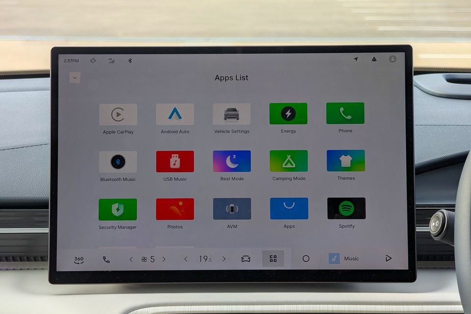 The Apps List screen on a Geely GX5 Inspire's infotainment touchscreen, showing icons for Apple CarPlay, Android Auto, Spotify, and other apps