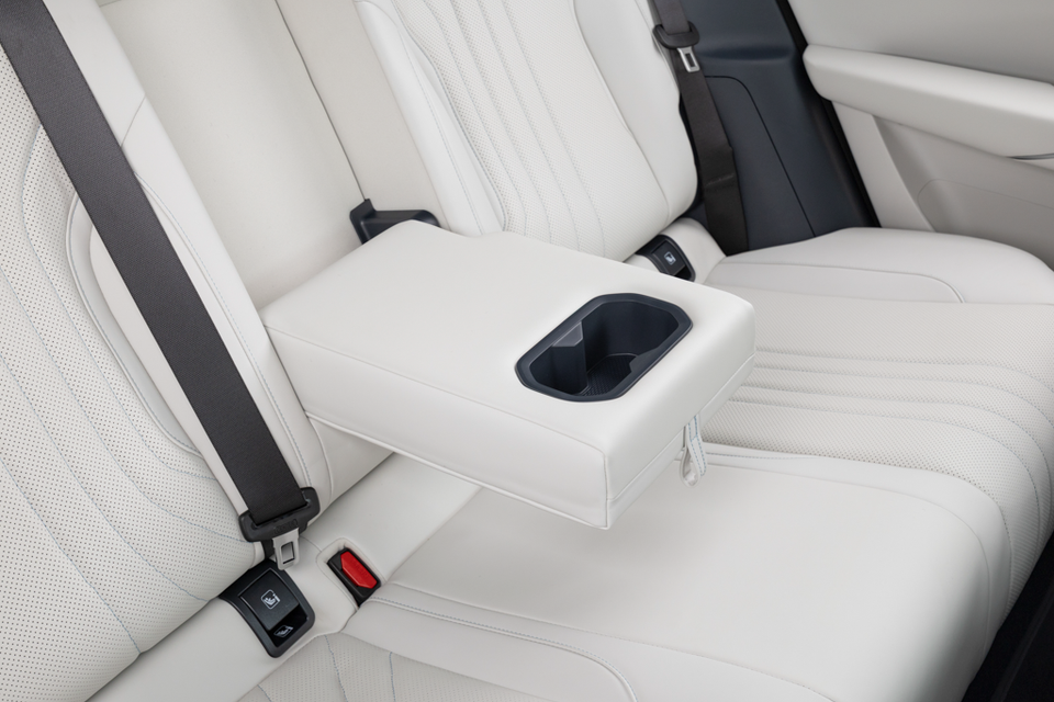 Rear seats of the 2027 Geely Starray EM-i in light grey perforated leather with a fold-down centre armrest and cupholder