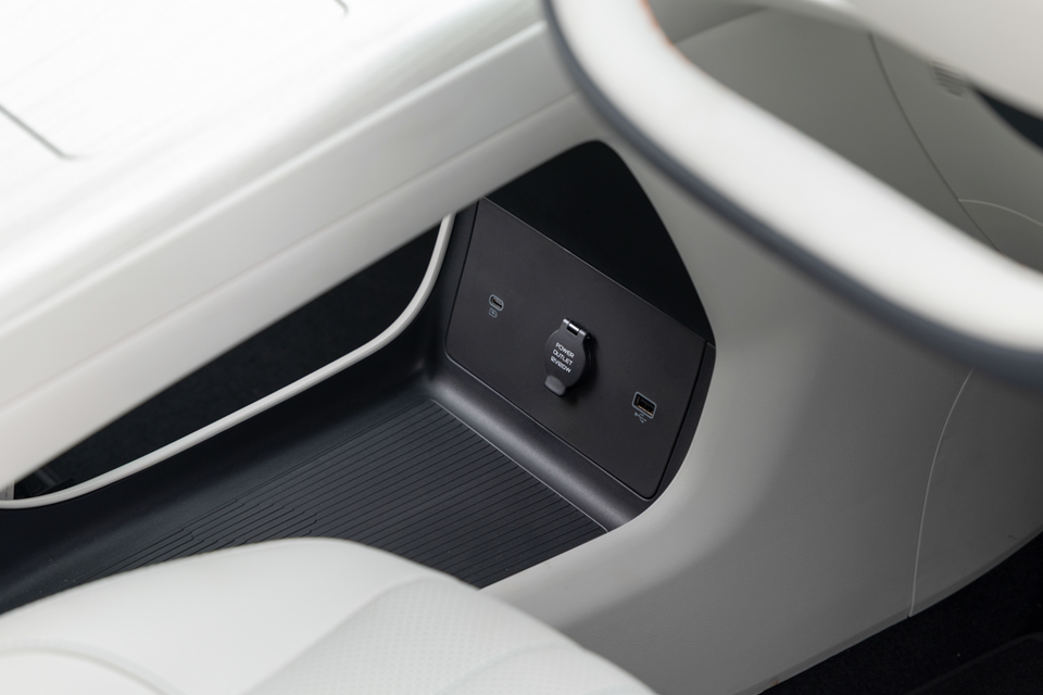 Lower centre console of the 2027 Geely Starray EM-i with USB-C, USB-A and 12V power outlets beneath a cream floating console