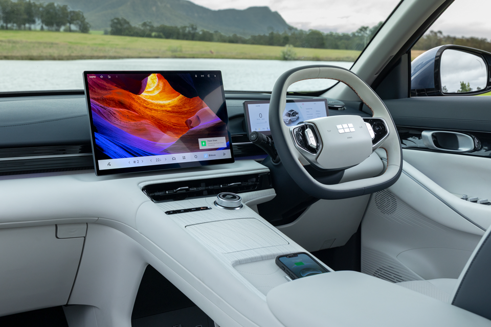 Light grey dashboard of the 2027 Geely Starray EM-i Inspire with a large central touchscreen, digital driver display, steering wheel and centre console