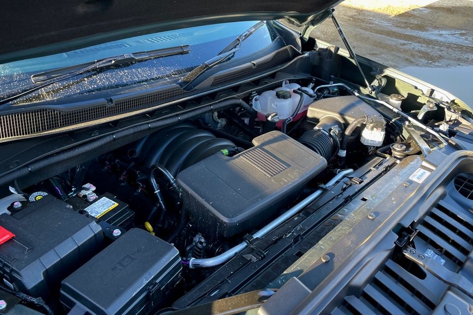 Engine bay of a 2027 GMSV Chevrolet Silverado ZR2 with the bonnet open, showing the engine, air intake, and fluid reservoirs