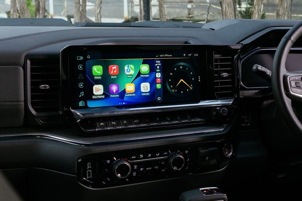 The large touchscreen infotainment display in a 2027 GMSV Chevrolet Silverado ZR2, showing Apple CarPlay with apps including Phone, Music, Maps and Messages, alongside climate controls below