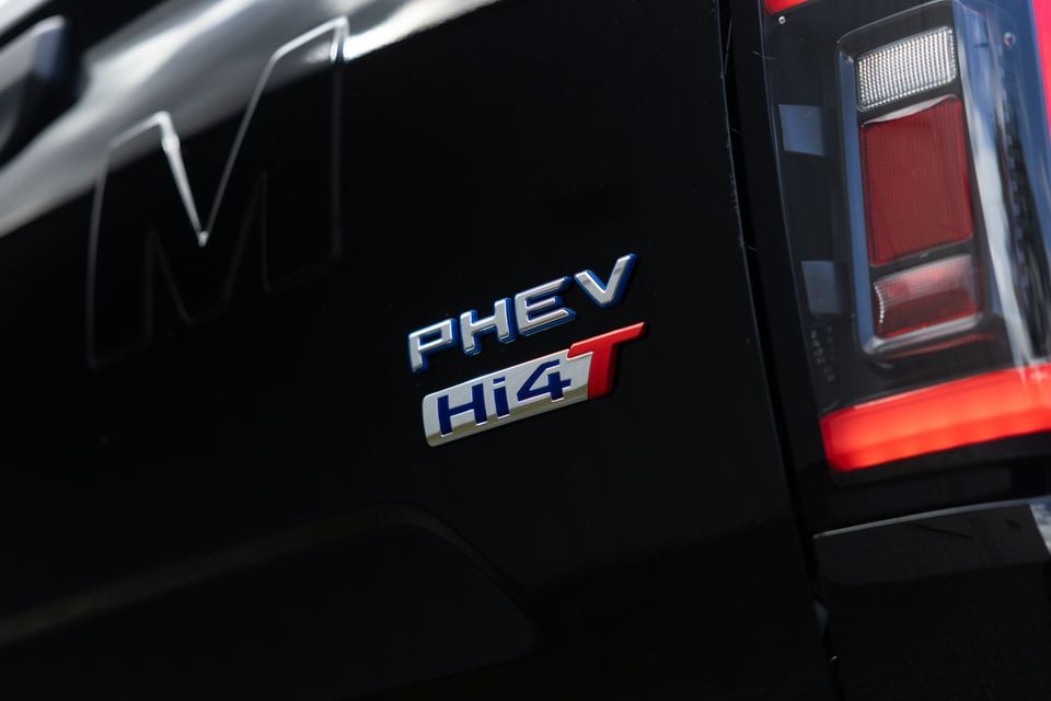 Close-up of the PHEV Hi4T badge on the rear of a black GWM Cannon ute